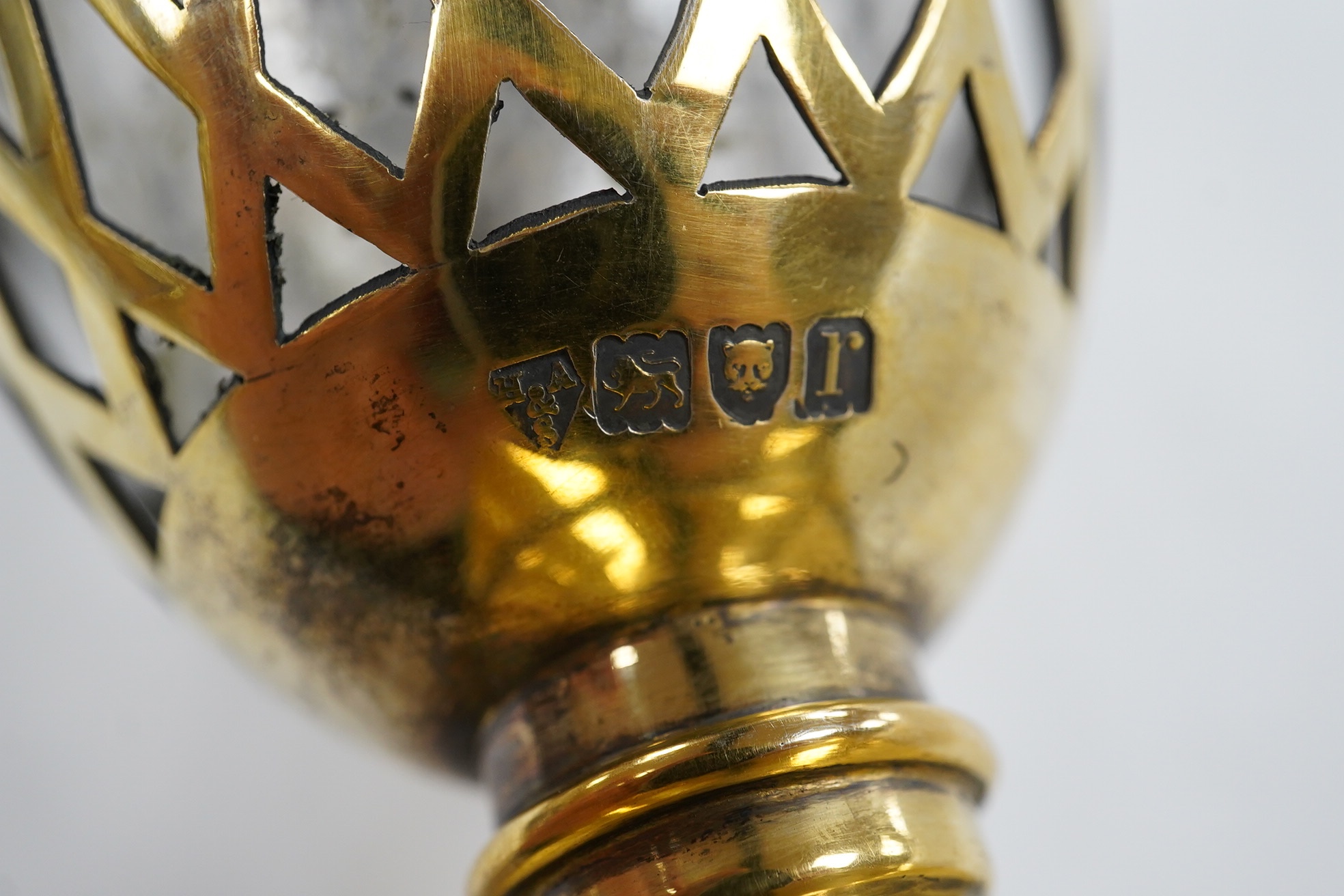 A George V pierced silver gilt two handled sugar vase and cover, by Holland, Aldwinckle & Slater, London, 1912, with clear glass liner, height 17.7cm, 9.7oz. Condition - fair to good
